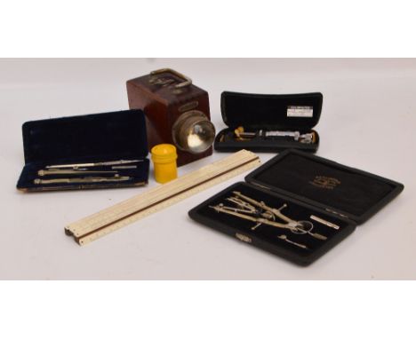 Two cased drawing instruments including one by Thornton Ltd of Manchester, a W Faber "Castell" sliding ruler, a vintage "Ever