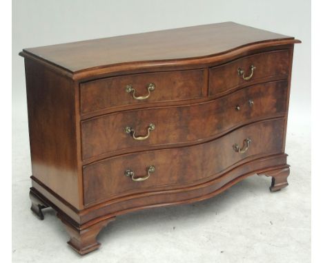 A 19th century mahogany serpentine chest of two short and two long drawers raised on ogee bracket feet, width 127.5cm.