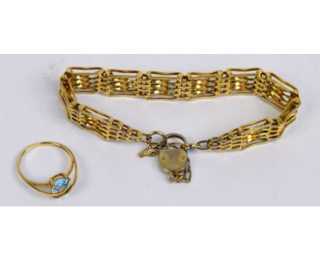 A 9ct yellow gold dress ring set with oval faceted topaz, size P½, and a gold plated gate link bracelet with padlock clasp an