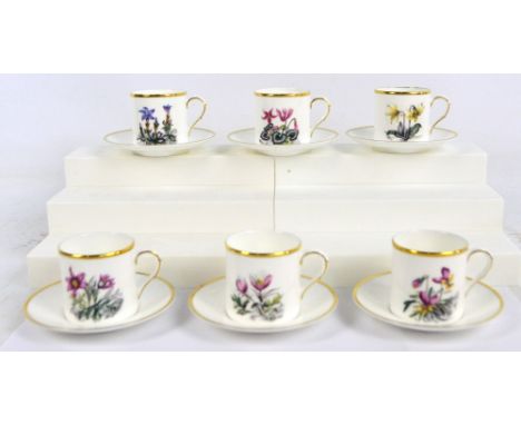 A set of six Royal Worcester coffee cans and saucers with different flower painted decoration, contained in a Royal Worcester