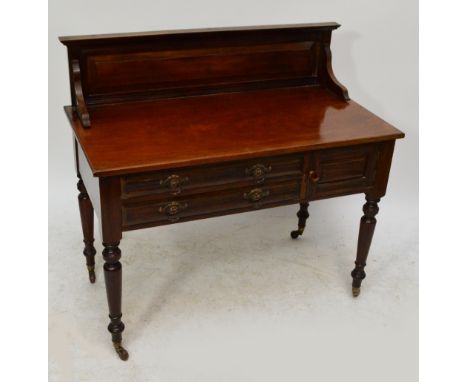 A Heal & Son of London mahogany wash stand with raised back, two drawers, cupboard door and ring turned legs to brass caps an