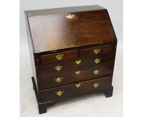 A George III mahogany bureau with fitted interior above two short and three long drawers raised on bracket feet, width 89cm.