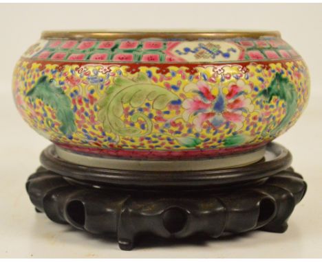 A 19th century Chinese Canton porcelain bowl of squat globular form painted in enamels with floral and foliate sprays on yell