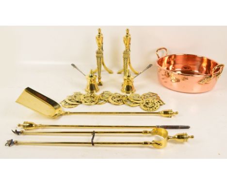 A group of metalware including a pair of brass andirons, fire tools, horse brasses and a copper shallow twin handled pan. CON