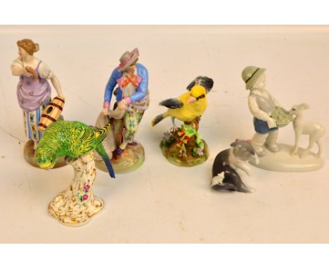 A pair of late 19th/early 20th century Continental porcelain figures depicting a fisherman with a net and a woman holding a f