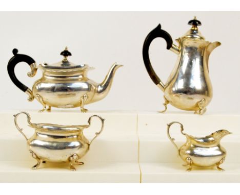 A George V hallmarked silver three piece bachelor's tea set comprising a teapot of rounded rectangular form with shaped top r