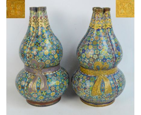 A near pair of 18th century Chinese cloisonné enamel decorated trilobed double gourd vases, overall decorated with various fl