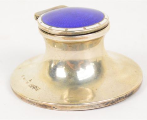 An Edwardian small hallmarked silver capstan style inkwell, the hinged lid decorated with a central panel of guilloche dark b