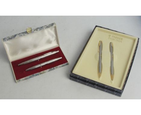 A boxed Elizabeth II hallmarked silver ball pen with overall engine turned decoration, Birmingham 1972, and a Parker "Insigni