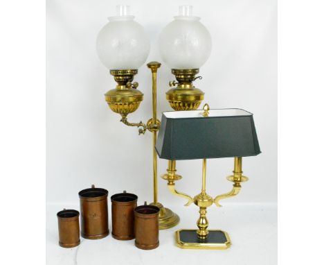 A brass adjustable double oil lamp with frosted glass globular floral decorated shades, height of stem 62cm, and a decorative