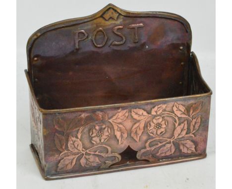 An Art Nouveau copper wall mounted post rack with embossed floral decoration, width 25cm. CONDITION REPORT: Old patch just ab