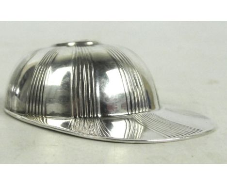 A George V jubilee hallmarked silver caddy spoon modelled as jockey's cap with radiant fluted decoration, maker's initials WE