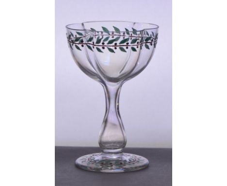 Attributed to LOBMEYR; a hollow stem champagne glass with quatrilobed bowl enamel decorated with a band of leaves, baluster s