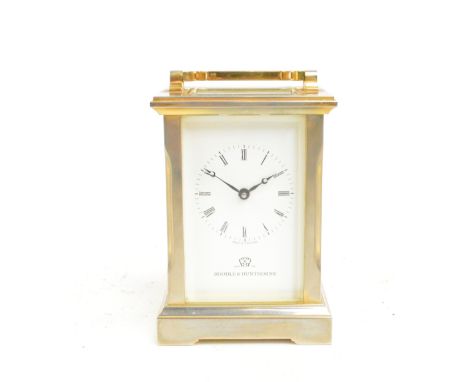 BOODLE & DUNTHORNE; a boxed contemporary carriage clock with swing loop handle above white dial set with Roman numerals, heig