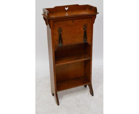 An Arts and Crafts oak student's bureau, the three quarter pierced gallery set with three cut heart shaped motifs above fall 