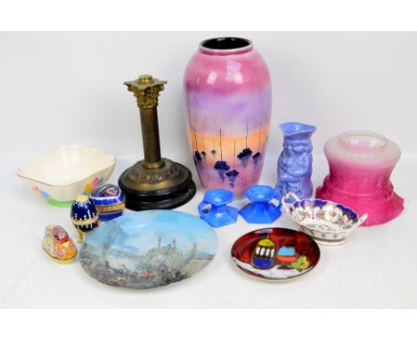 A decorative vase, a Burlington Ware character jug, a pair of candlesticks and part of a brass oil lamp with cranberry tinted