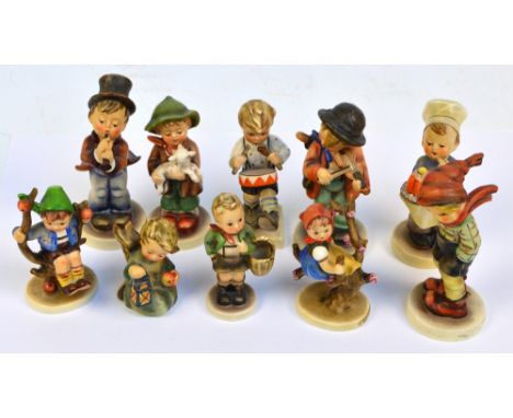 A group of ten Hummel figures including a boy playing a drum, boy playing a violin (af), a cook with a cake and a cherub with