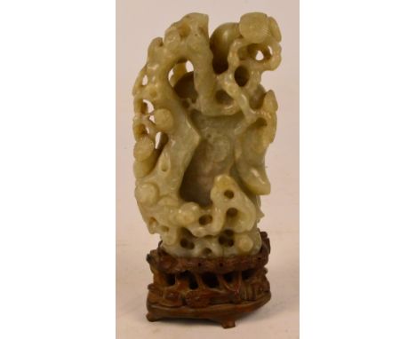 A fine Chinese 18th/19th century carved jade figure of Shou Lao leaning on a staff beside pine trees with a crane at his feet