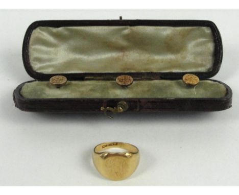 An 18ct yellow gold gentleman's signet ring with initials, size F/G, and a cased set of three yellow metal dress studs with s