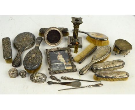 A quantity of silver including an octagonal trinket box, circular frame, dressing table items, also a plated loaded candlesti