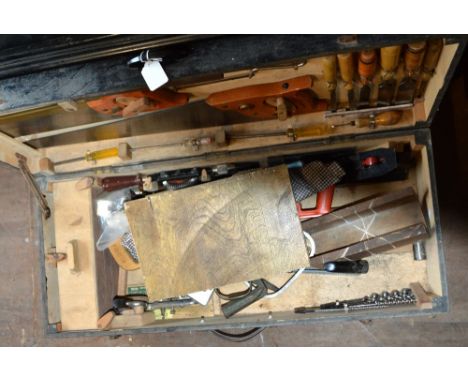 A wooden tool box stencilled P T CROCKER with hinged lid, containing woodworking tools including, planes, saws, chisels, a fo