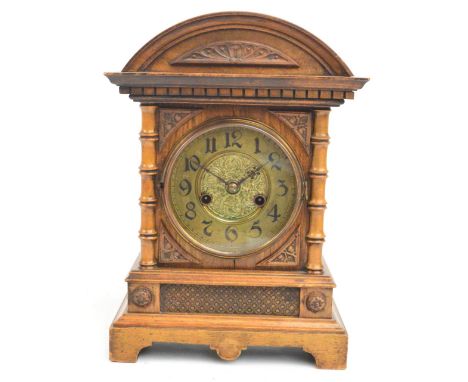 A c.1900 German walnut fourteen day strike mantel clock with domed top above circular brass dial set with Arabic numerals fla