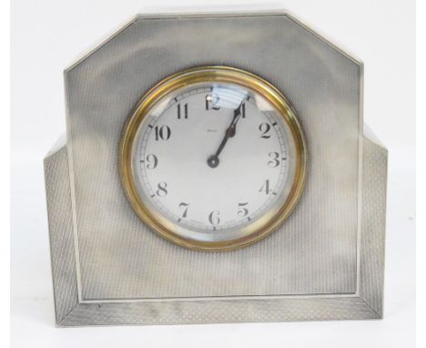 A French Art Deco style engine turned decorated pewter cased eight day mantel timepiece, the circular dial set with Arabic nu