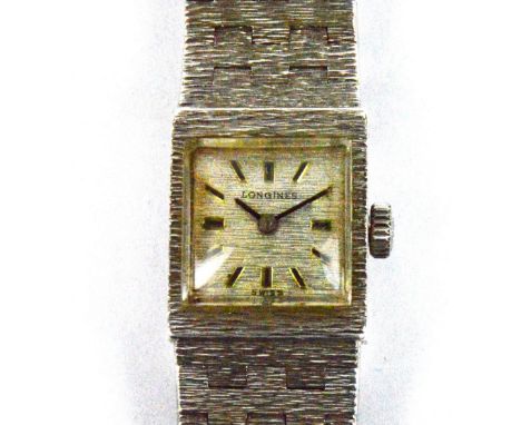 LONGINES; a silver cased manual wind lady's wristwatch, the square silvered dial set with baton numerals with integral articu