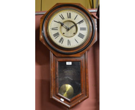 A mahogany cased American Ansonia wall clock, the circular chapter ring set with Roman numerals, surrounded by octagonal fram