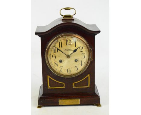 An early 20th century mahogany and brass detailed bracket clock, the circular silvered dial set with Arabic numerals inscribe