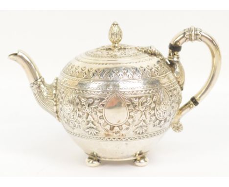 A Victorian hallmarked silver globular teapot with band of embossed decoration, loop handle, bud finial and four squat feet, 