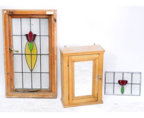 A rustic pine bathroom hanging cupboard with hinged mirrored door enclosing one shelf, width 46cm, a yellow, green and red st