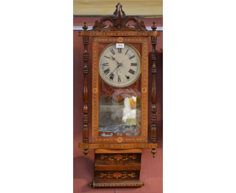 An early 20th century inlaid eight day wall clock with shaped carved pediment above circular dial set with Roman numerals fla