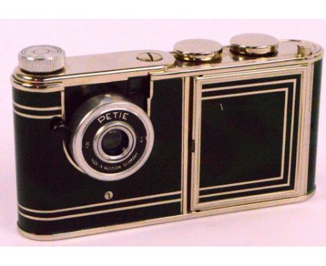 A 1950s West German "Petie" vanity camera with marbled green effect body, camera section, spare film within film section, lip