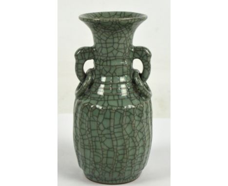 A 20th century Chinese porcelain celadon crackle glaze vase of baluster form with wrythen decoration to the lower part and ri