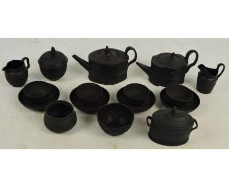 A collection of 19th century black basalt ware comprising two unnamed shaped teapots, a Turner oval twin handled sugar box an