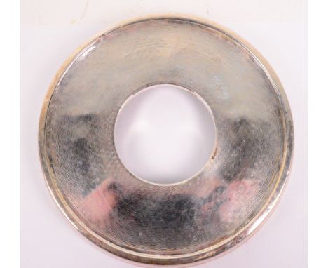 A George V hallmarked silver and bakelite circular teapot stand with engine turned decoration underneath, Joseph Gloster Ltd,