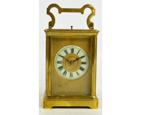 A late 19th century French brass cased repeating carriage clock with swing loop handle above circular dial set with Roman num