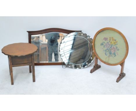 A circular fire screen with trestle stand, with hinge to convert into occasional table, set with a floral woolwork picture, a