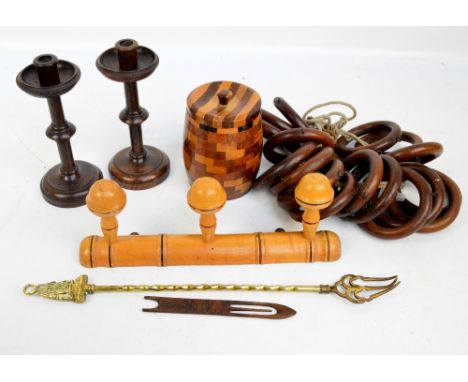 A small quantity of treen objects comprising a pair of knopped oak candlesticks, a circular tea caddy, coat hooks, curtain ri