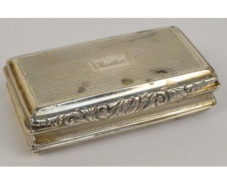 A George IV hallmarked silver snuff box of rectangular form with scrolling decoration to the thumb piece, gilt wash interior,