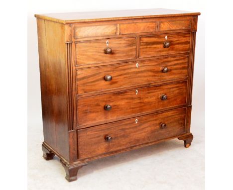 A large mid 19th century mahogany chest of drawers with one central concealed drawer flanked by two dummy drawers, then two s