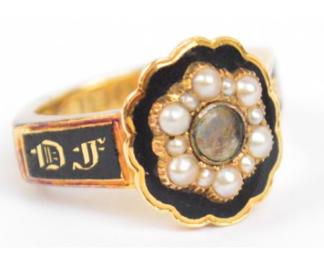 An 18ct yellow gold mourning ring decorated with black enamel and seed pearls centred with a small aperture for hair, the sha