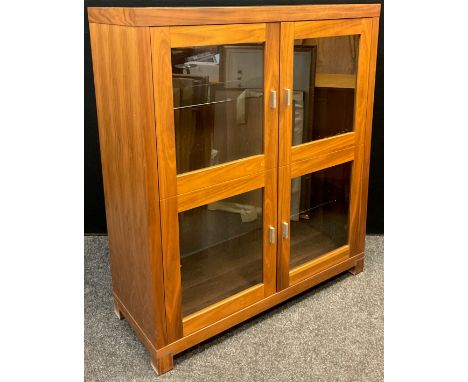 A modern teak two door display cabinet, three shelf interior 119cm high x 103cm wide x40cm deep 