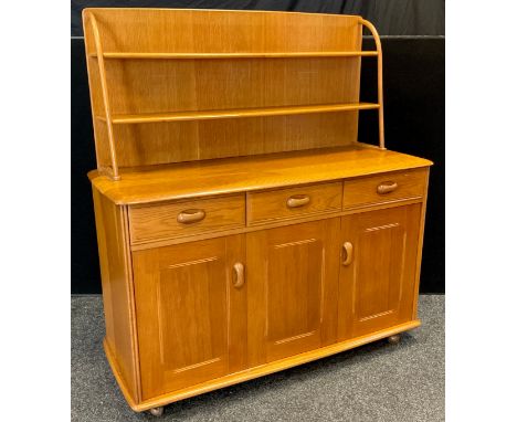 An Ercol elm and oak Danish style dresser, plate rack top, rounded rectangular top, three short drawers over pair of cupboard