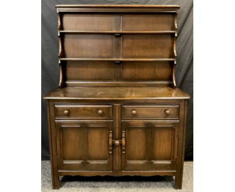 An Ercol elm dresser, two tier plate-rack top, above a base with rounded rectangular top, and pair of short drawers over two 