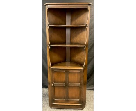 An Ercol elm floor standing corner cupboard / shelving unit, 184cm high x 71cm wide. 