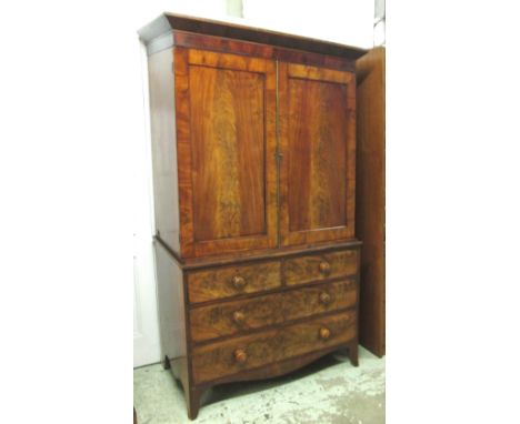 LINEN PRESS, George IV mahogany with a pair of panelled doors above enclosing sliding trays and two short over two long drawe