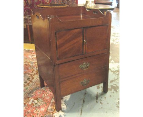 BEDSIDE COMMODE, George III mahogany with a galleried tray top and a pair of panelled doors over a sliding false drawer front