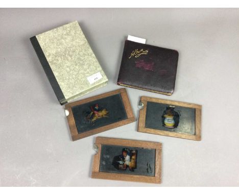 THREE VICTORIAN MOVEABLE MAGIC LANTERN SLIDES,along with an autograph/sketch book